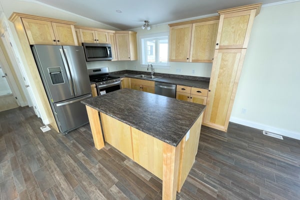 Kitchen with square island and stainless steel appliances